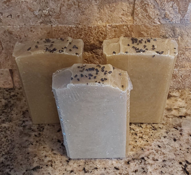 Sea of Galilee Soap, greenish gold with black lava salt on top. Sweet amber and floral scent
