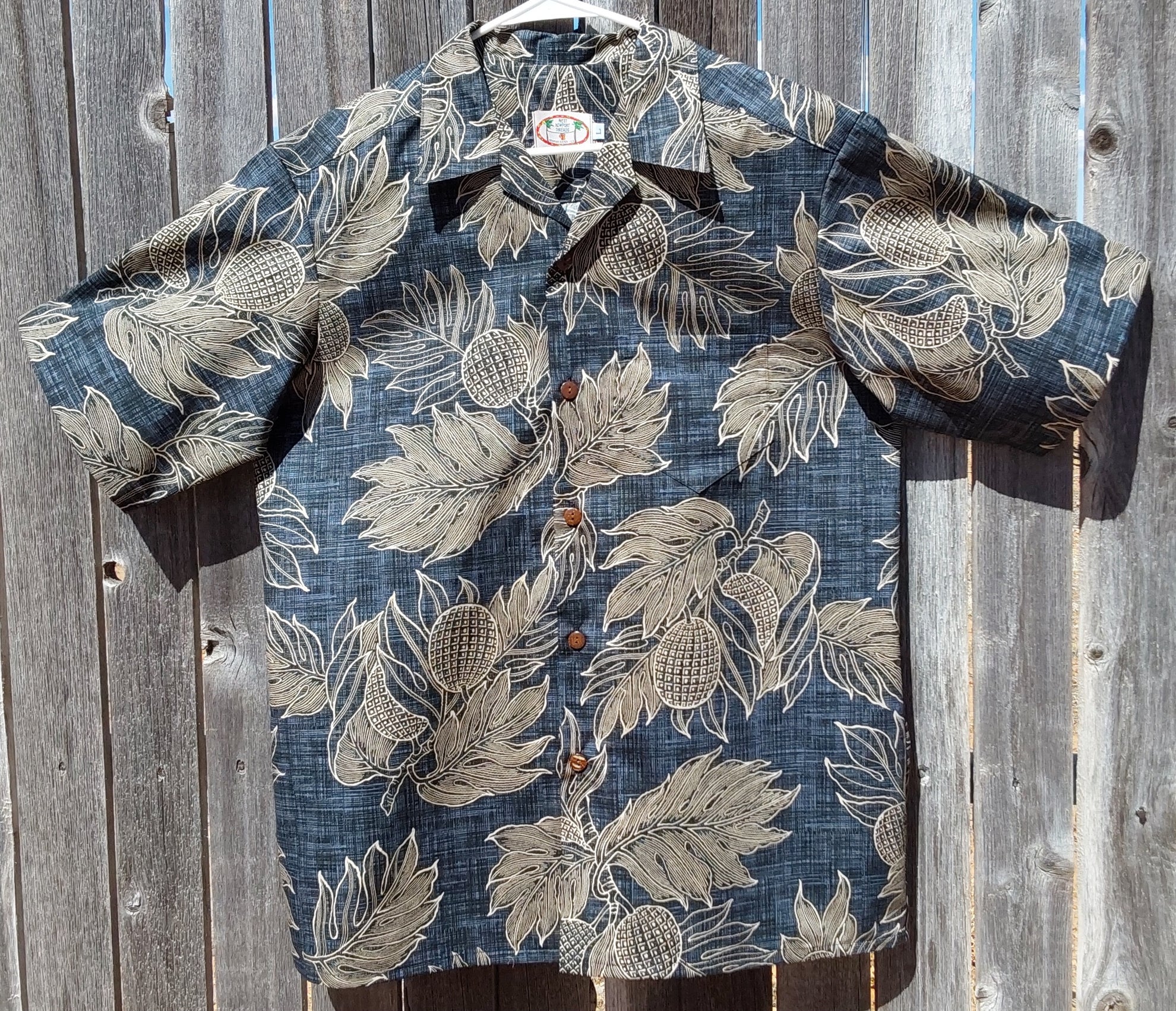 Ulu Breadfruit shirt. Dark gray with a black grasscloth grid covered with line drawings of pale gold/tan breadfruit and leaves